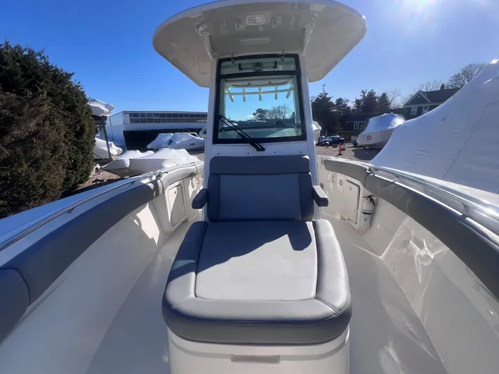  Yacht Photos Pics 2022 Boston Whaler 280 Outrage boat interior with seating and console under clear blue sky.