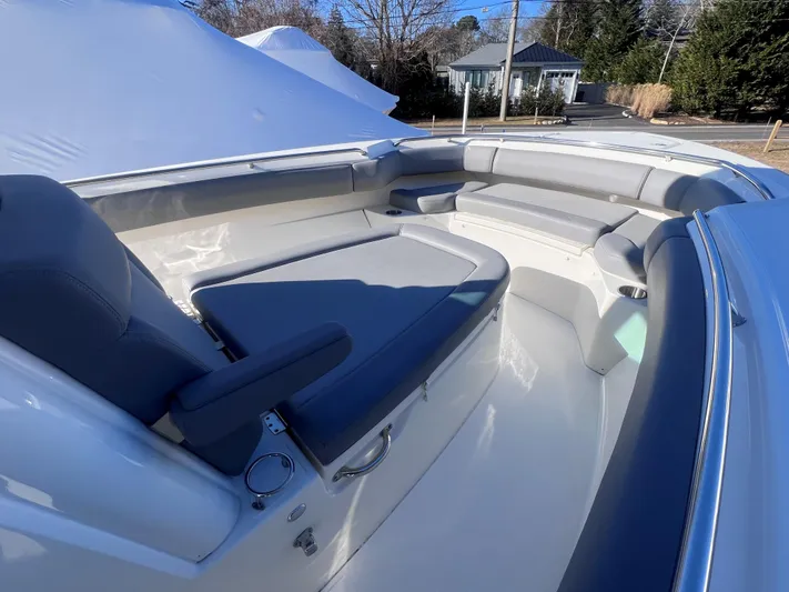  Yacht Photos Pics 2022 Boston Whaler 280 Outrage boat interior with cushioned seating and sleek design.