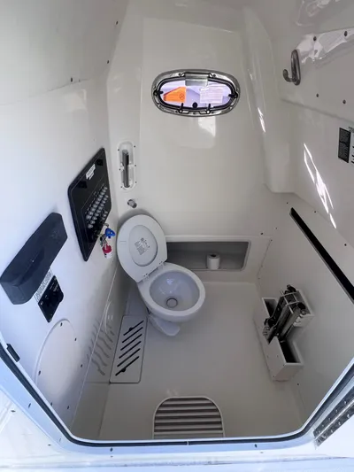  Yacht Photos Pics Interior of 2022 Boston Whaler 280 Outrage boat, featuring a compact marine toilet.