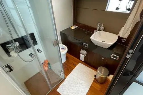  Yacht Photos Pics Luxurious bathroom in 2015 Fairline SQUADRON 67 yacht with modern fixtures and glass shower.