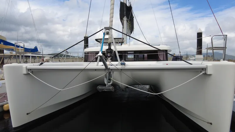  Yacht Photos Pics 2019 Lagoon 450S catamaran docked at marina, front view with sails and rigging visible.