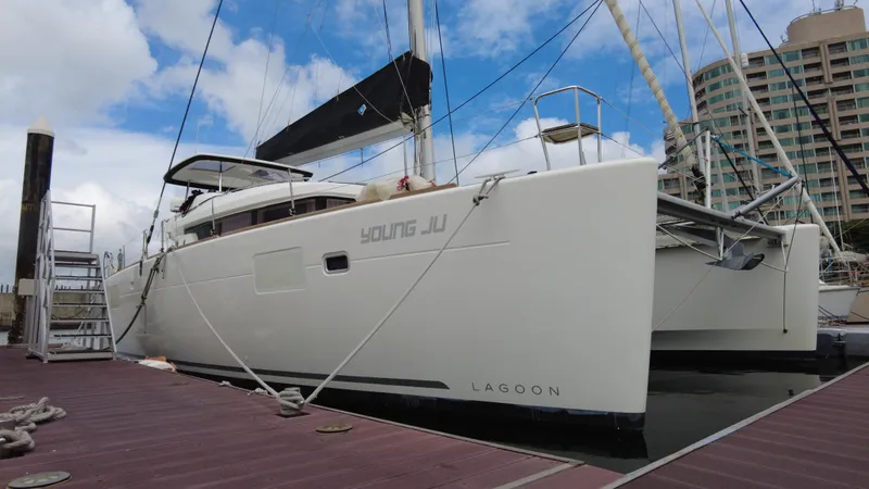  Yacht Photos Pics 2019 Lagoon 450S catamaran docked at marina under blue sky.