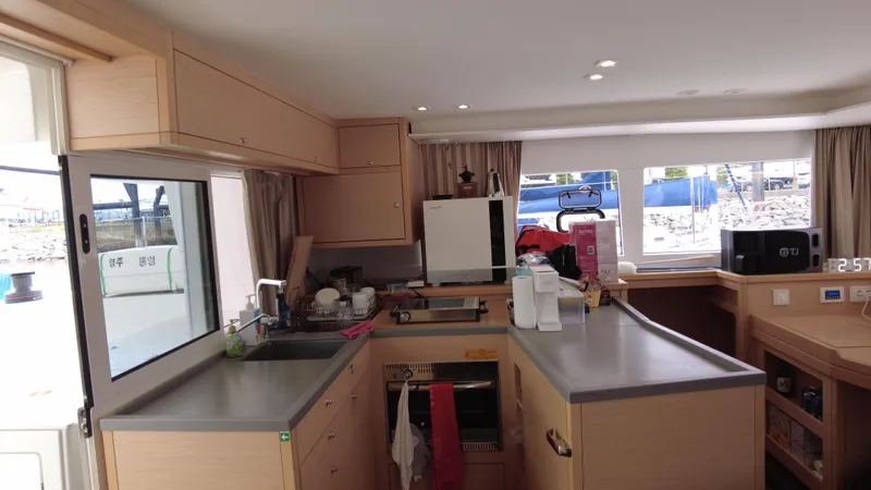  Yacht Photos Pics Interior of a 2019 Lagoon 450S yacht kitchen with modern amenities and ample counter space.