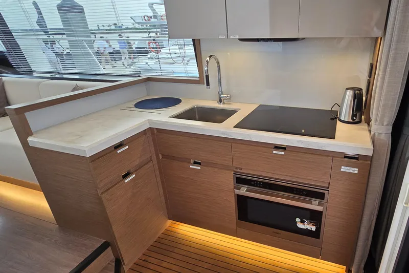 Yacht Photos Pics Modern kitchen in 2022 Monte Carlo MC52 yacht with sleek appliances and wood cabinetry.