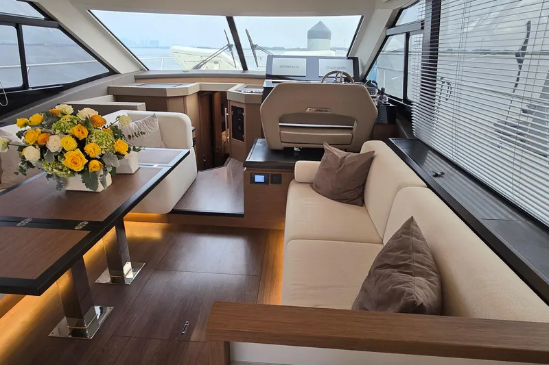  Yacht Photos Pics Luxurious interior of 2022 Monte Carlo MC52 yacht with elegant seating and floral arrangement.
