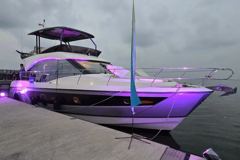  Yacht Photos Pics Luxury Monte Carlo MC52 yacht docked with ambient purple lighting, 2022 model.