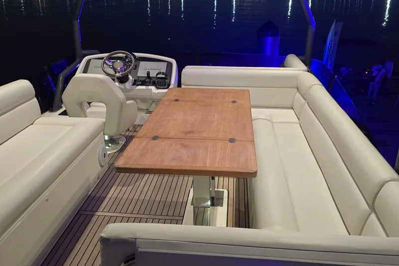  Yacht Photos Pics Luxurious 2022 Monte Carlo MC52 yacht interior with elegant seating and wooden table.