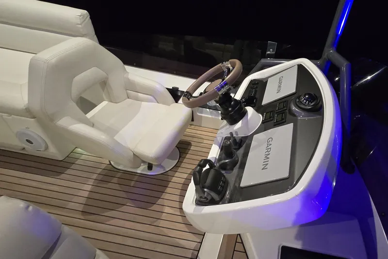  Yacht Photos Pics 2022 Monte Carlo MC52 helm with Garmin navigation, luxurious seating, and modern controls.