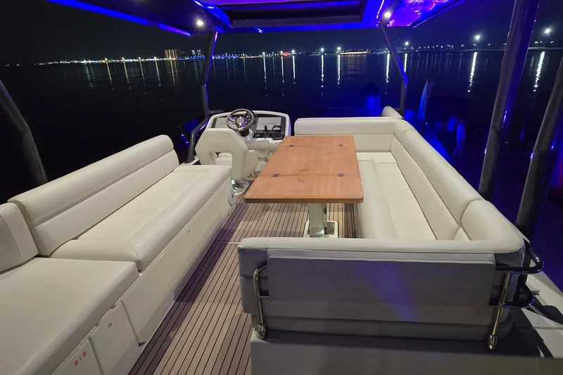  Yacht Photos Pics Luxurious 2022 Monte Carlo MC52 yacht interior with elegant seating and ambient lighting at night.