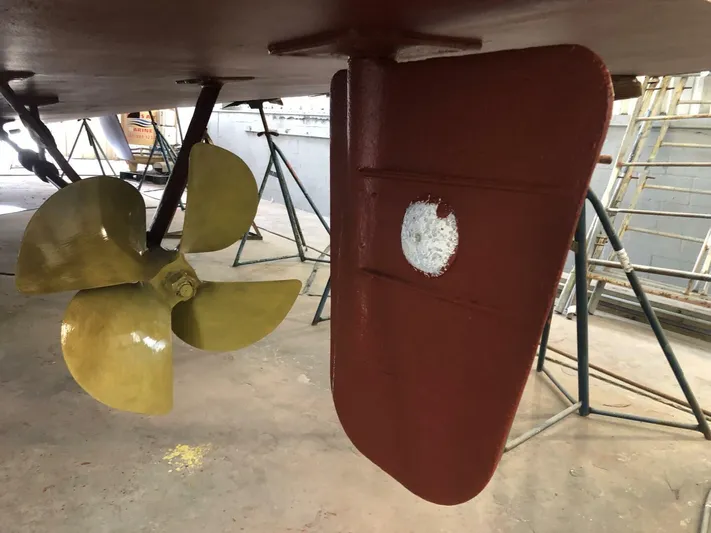 Dovetail Yacht Photos Pics Close-up of 1972 Trumpy 72 Houseboat propeller and rudder during maintenance.