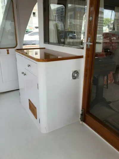 Dovetail Yacht Photos Pics 1972 Trumpy 72 Houseboat interior with wooden accents and cabinetry.
