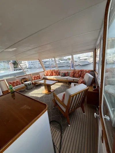 Dovetail Yacht Photos Pics Spacious interior of a 1972 Trumpy 72 Houseboat with comfortable seating and panoramic windows.