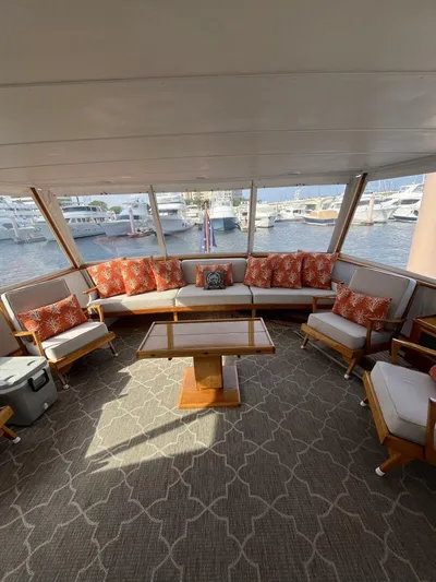 Dovetail Yacht Photos Pics Spacious interior of a 1972 Trumpy 72 Houseboat with comfortable seating and marina view.