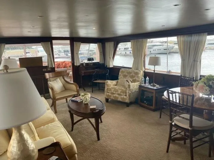 Dovetail Yacht Photos Pics Interior of a 1972 Trumpy 72 Houseboat with elegant furnishings and large windows.