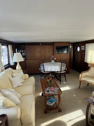 Dovetail Yacht Photos Pics Interior of a 1972 Trumpy 72 Houseboat with cozy seating and dining area.