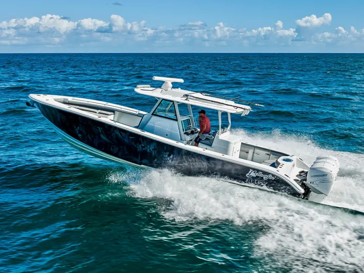  Yacht Photos Pics 2021 Yellowfin 39 boat cruising on open ocean under clear skies.