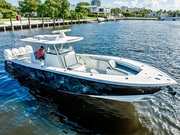  Yacht Photos Pics 2021 Yellowfin 39 boat on water, featuring sleek design and spacious seating.