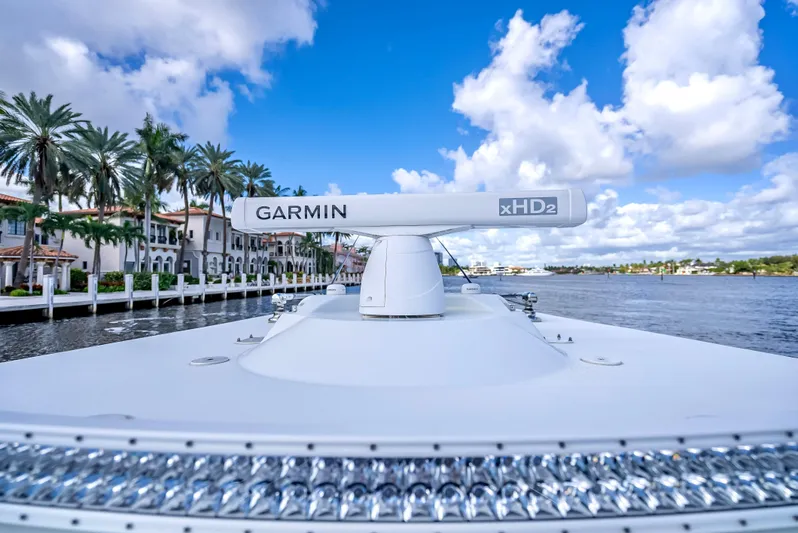  Yacht Photos Pics 2021 Yellowfin 39 boat with Garmin radar, cruising near waterfront homes under blue skies.