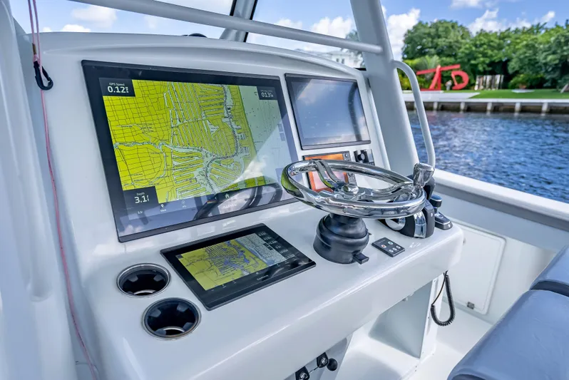 Yacht Photos Pics 2021 Yellowfin 39 boat dashboard with navigation screens and steering wheel.