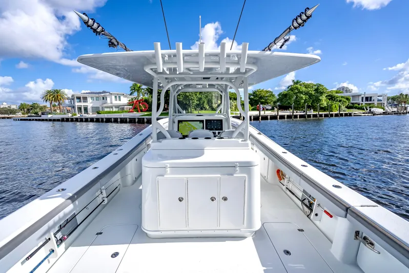  Yacht Photos Pics 2021 Yellowfin 39 boat on calm water, clear sky, luxurious waterfront homes.