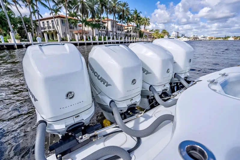  Yacht Photos Pics 2021 Yellowfin 39 boat with four Mercury outboard engines on a scenic waterfront.