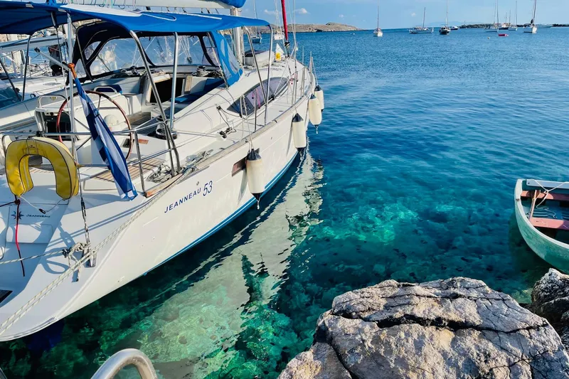  Yacht Photos Pics Jeanneau 53 sailboat docked in clear blue water, 2011 model.