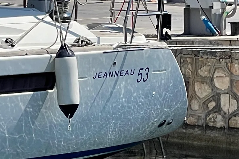  Yacht Photos Pics 2011 Jeanneau 53 yacht docked, showing hull and fender in marina setting.
