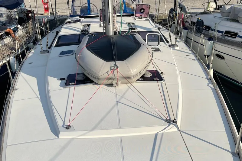  Yacht Photos Pics 2011 Jeanneau 53 yacht deck with inflatable dinghy, docked in marina.