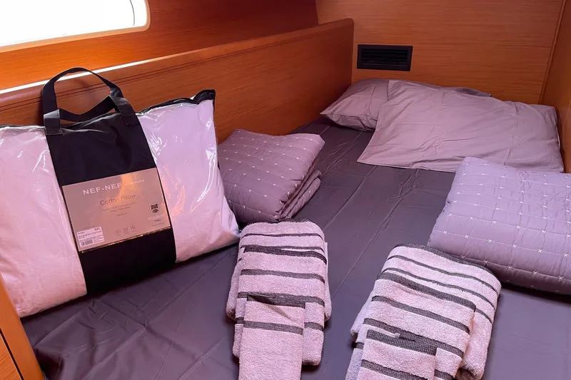  Yacht Photos Pics Cozy cabin interior of 2011 Jeanneau 53 yacht with neatly arranged bedding and towels.