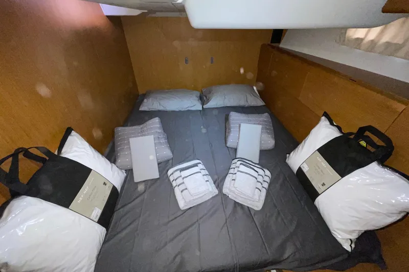  Yacht Photos Pics Cozy cabin interior of 2011 Jeanneau 53 yacht with neatly arranged bedding and pillows.