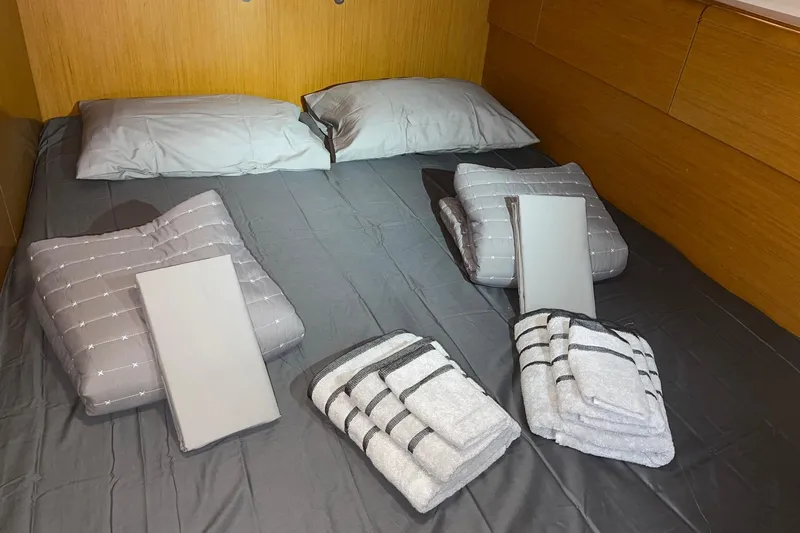  Yacht Photos Pics Luxurious cabin interior of 2011 Jeanneau 53 yacht with neatly arranged bedding and towels.