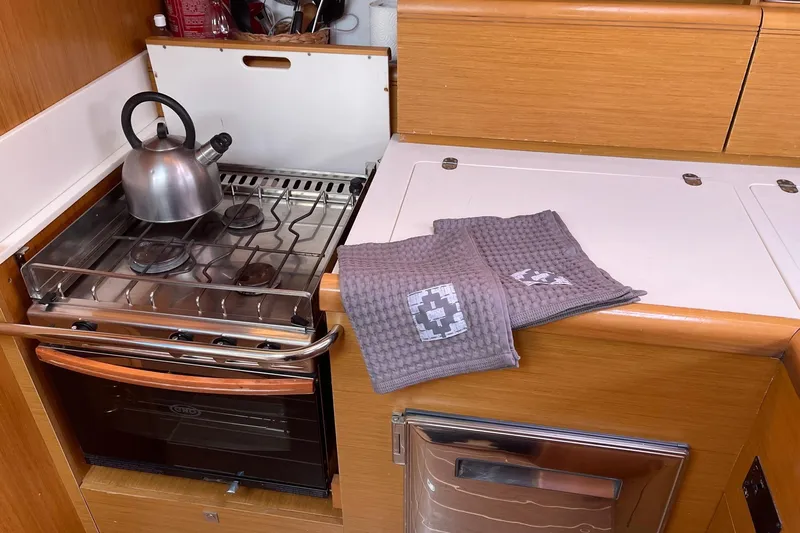  Yacht Photos Pics Galley kitchen in 2011 Jeanneau 53 yacht with stove, kettle, and towels.