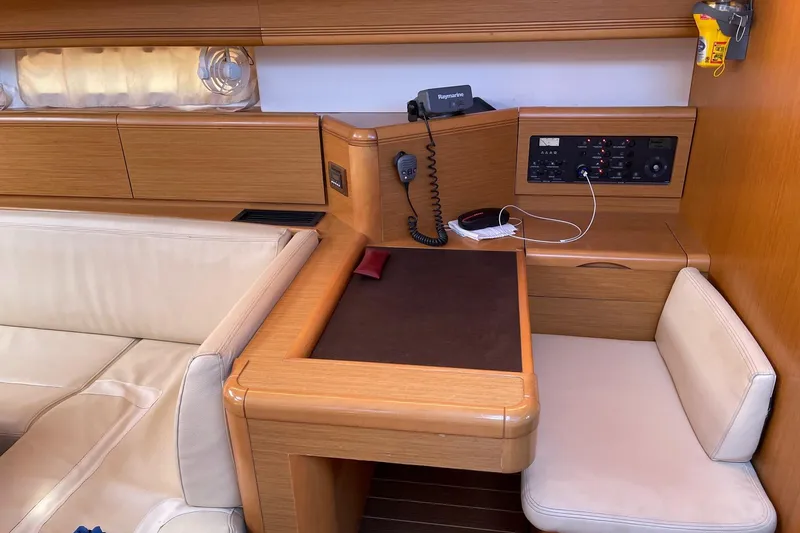  Yacht Photos Pics Navigation station in 2011 Jeanneau 53 yacht with beige seating and control panel.