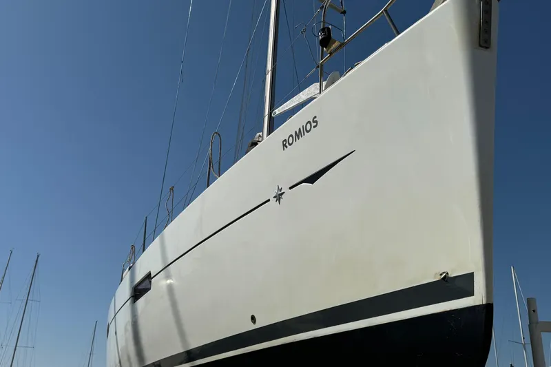  Yacht Photos Pics 2011 Jeanneau 53 sailboat, named Romios, against a clear blue sky.