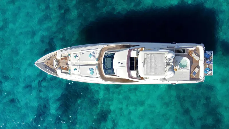 Yacht Photos Pics Aerial view of 2012 Custom Line 100 yacht on clear turquoise water.