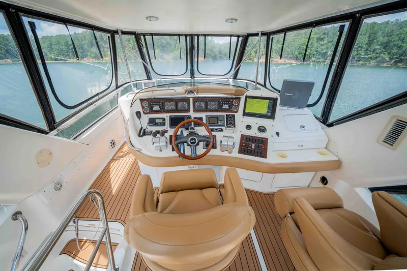  Yacht Photos Pics Luxurious 1999 Sea Ray 480 Sedan Bridge helm with leather seats and advanced navigation.
