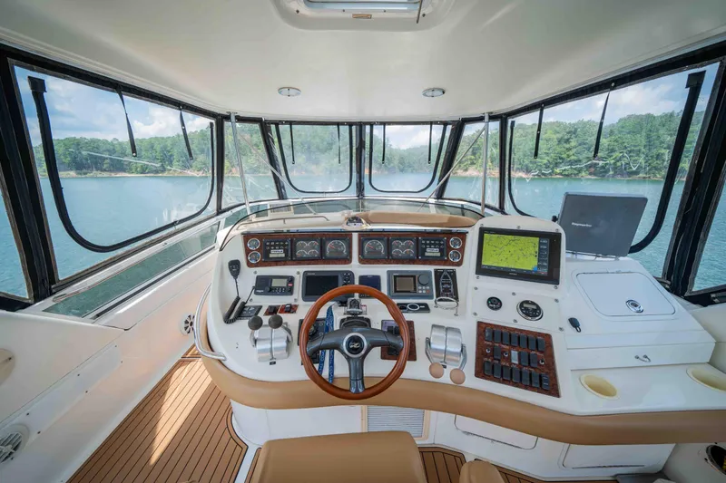  Yacht Photos Pics 1999 Sea Ray 480 Sedan Bridge helm with navigation equipment and panoramic water view.