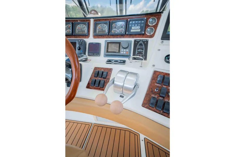  Yacht Photos Pics 1999 Sea Ray 480 Sedan Bridge helm with gauges, controls, and wood accents.