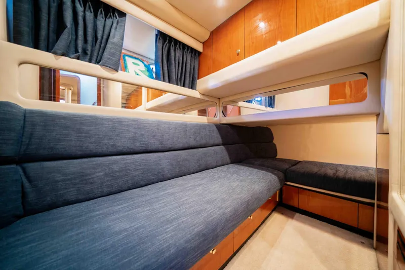  Yacht Photos Pics Interior of 1999 Sea Ray 480 Sedan Bridge with blue seating and wooden cabinets.