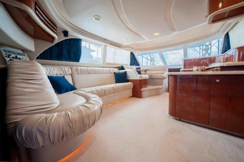  Yacht Photos Pics Luxurious interior of 1999 Sea Ray 480 Sedan Bridge yacht with plush seating and elegant design.