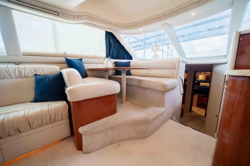  Yacht Photos Pics Luxurious interior of 1999 Sea Ray 480 Sedan Bridge yacht with plush seating and elegant decor.