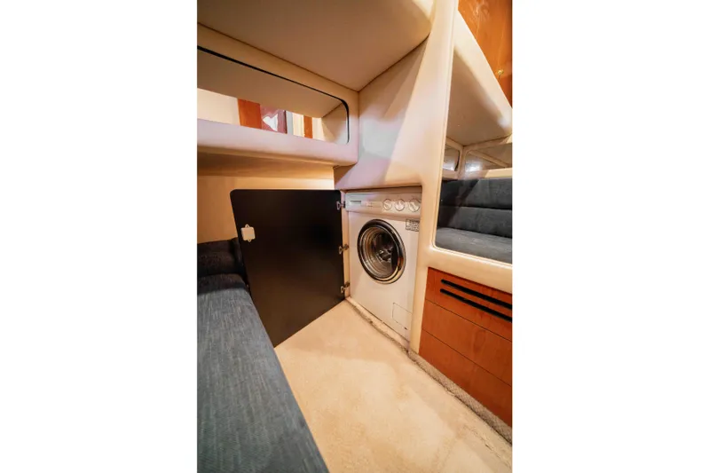  Yacht Photos Pics Laundry area inside 1999 Sea Ray 480 Sedan Bridge yacht, featuring a compact washing machine.