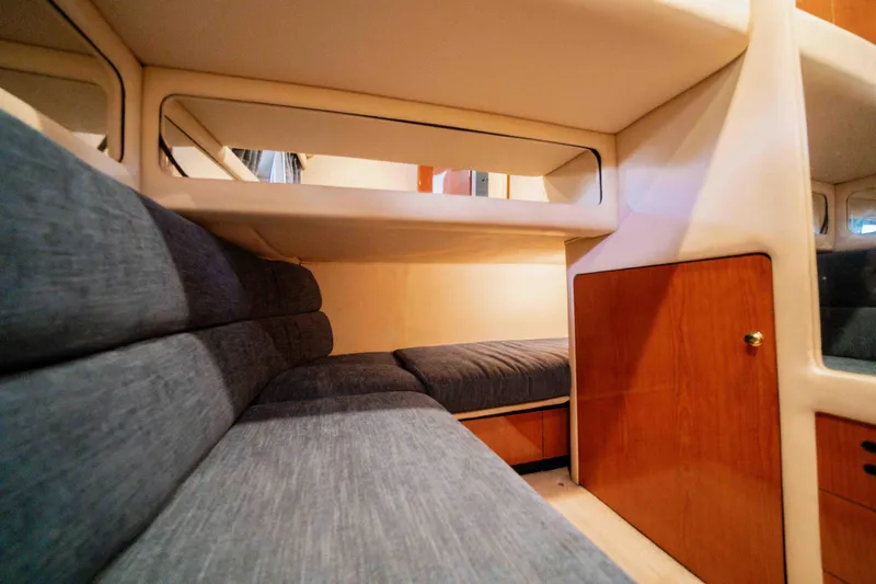  Yacht Photos Pics 1999 Sea Ray 480 Sedan Bridge interior cabin with blue seating and wooden cabinetry.