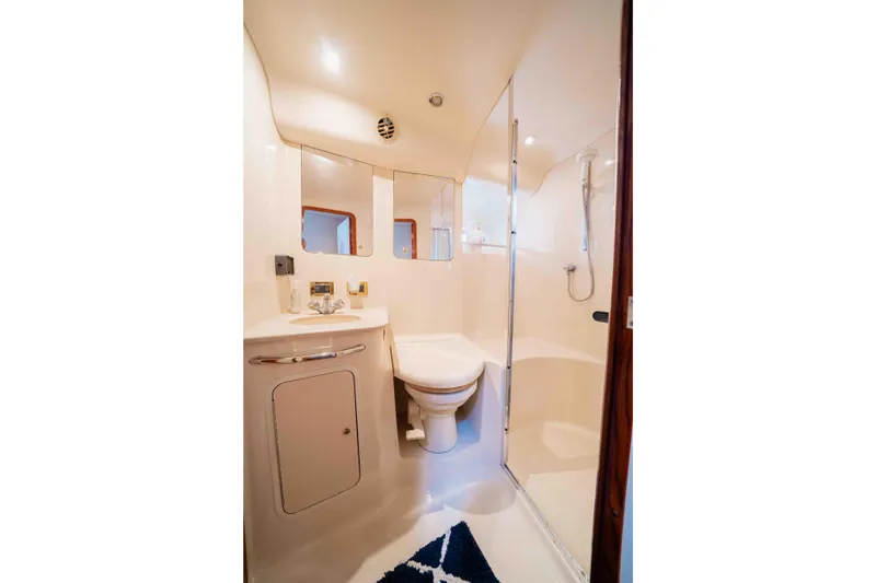  Yacht Photos Pics Luxurious bathroom in 1999 Sea Ray 480 Sedan Bridge yacht, featuring shower and vanity.