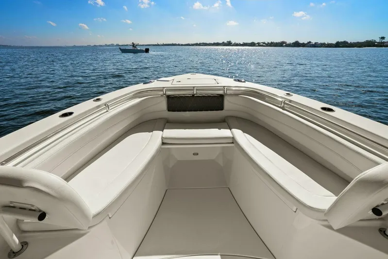  Yacht Photos Pics 2023 Cobia 301 Center Console boat interior with spacious seating on calm water.