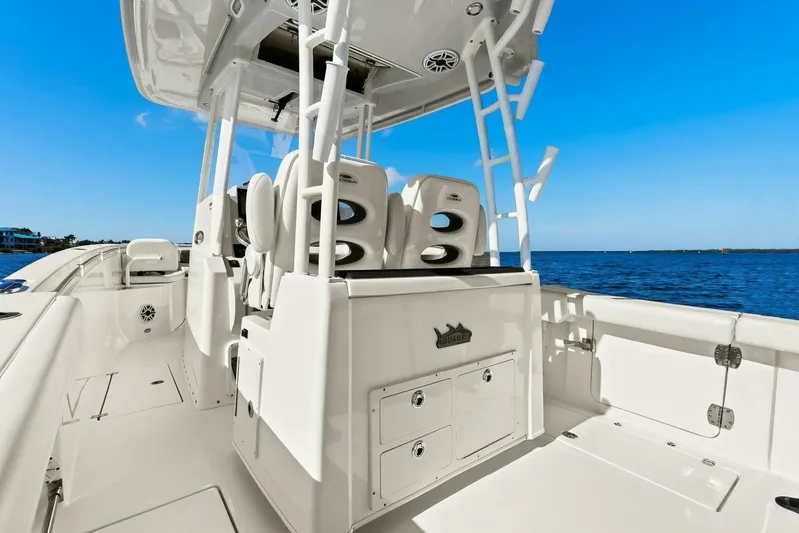  Yacht Photos Pics 2023 Cobia 301 Center Console boat interior with ocean view, featuring seating and storage.