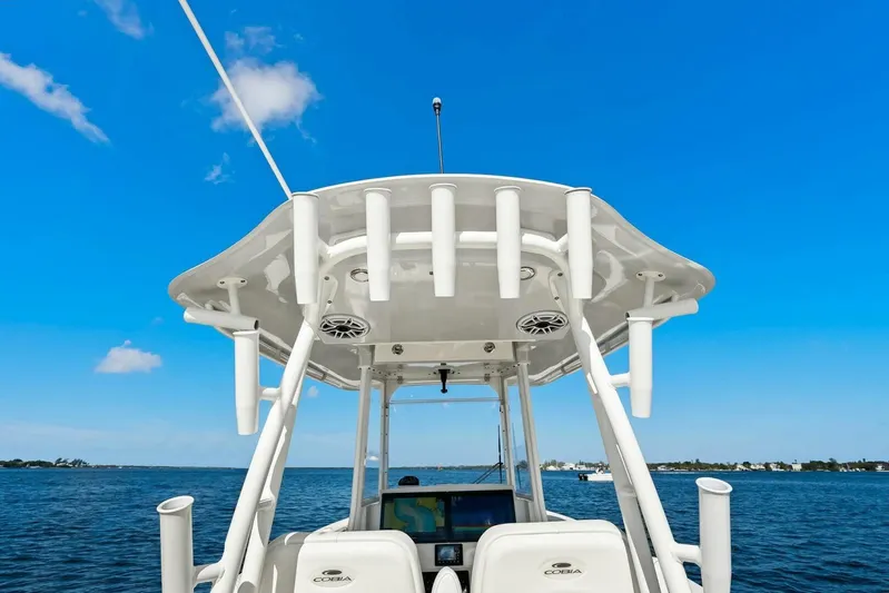  Yacht Photos Pics 2023 Cobia 301 Center Console boat on open water under clear blue sky.