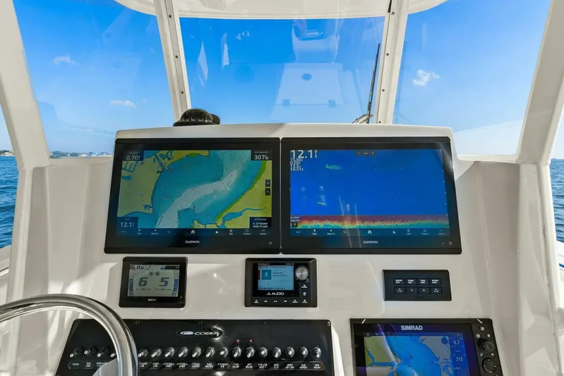  Yacht Photos Pics 2023 Cobia 301 Center Console dashboard with navigation and sonar displays.