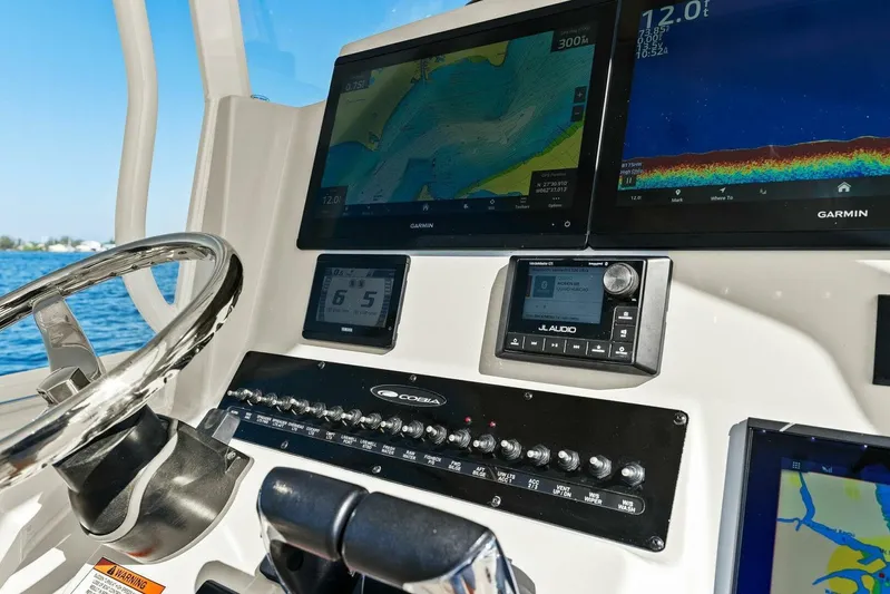  Yacht Photos Pics 2023 Cobia 301 Center Console dashboard with Garmin displays and JL Audio system.