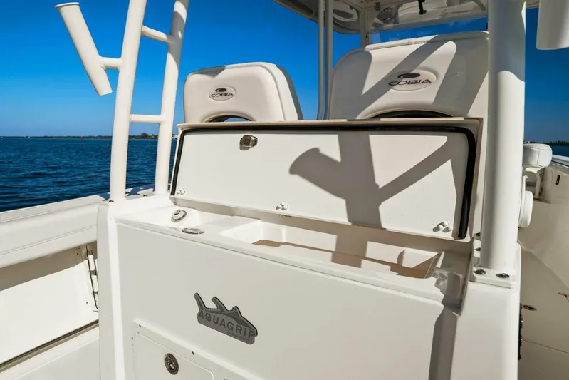  Yacht Photos Pics 2023 Cobia 301 Center Console boat interior with Aquagrip feature, ocean backdrop.